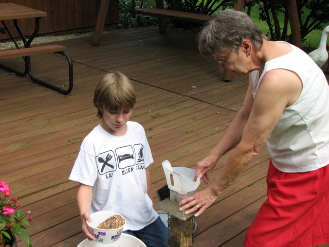 Filling the bird feeder with Grandma in Ohio